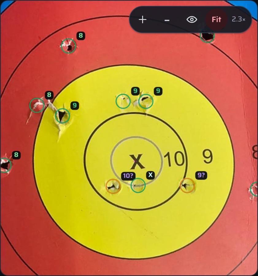 Zoomed into the gold: individual arrow holes with their scores, ready to nudge